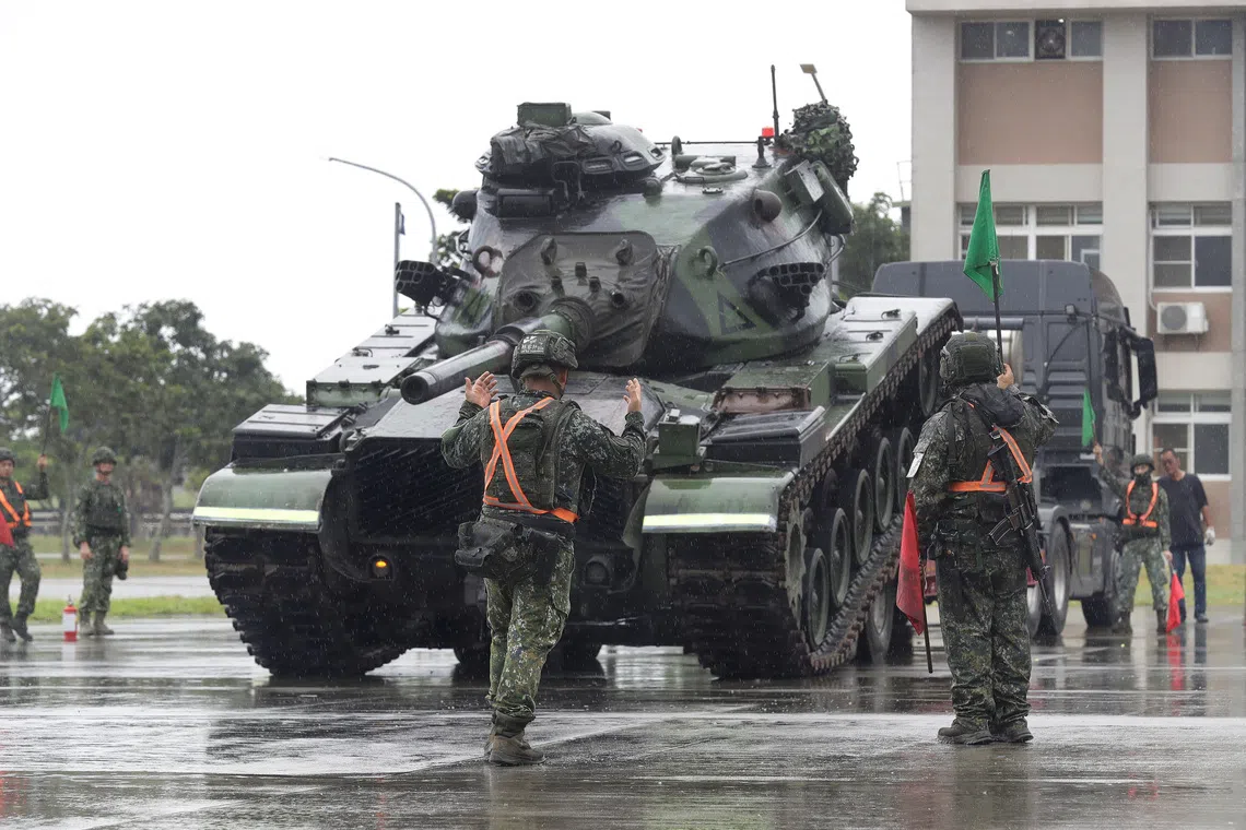Taiwanese soldiers practise active-duty force expansion and military vehicle flatbed loading during the annual Han Kuang military exercises.