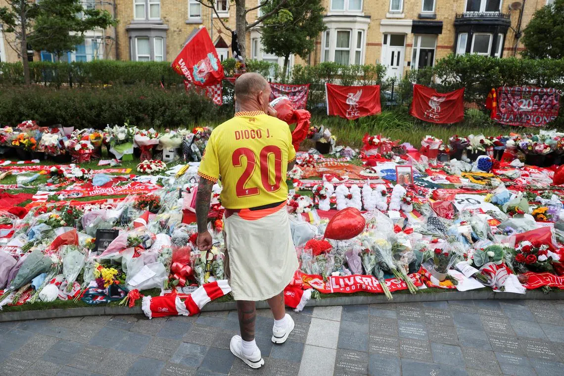 A fan pays his respects outside Anfield Stadium, on the day of the funeral of Liverpool player Diogo Jota in Portugal.