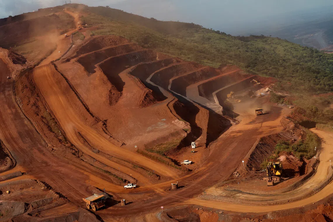 FILE PHOTO: Mining vehicles operate at the blocks three and four of the Simandou mine, one of the largest high-grade iron ore deposits, run by Rio Tinto and partners' joint venture, SimFer, in the Nzerekore Region, Guinea November 4, 2025. REUTERS/Luc Gnago/File Photo