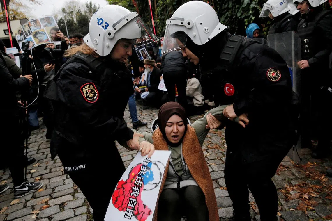 Uyghur demonstrators scuffle with riot police, Istanbul, November 30, 2022. REUTERS/Dilara Senkaya