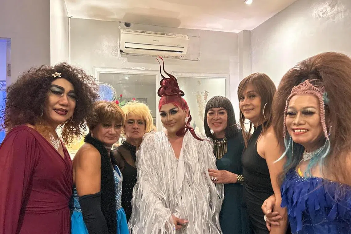 Precious Paula Nicole (in white) poses for a photo with the Golden Gays backstage at a gay bar in the Philippines.