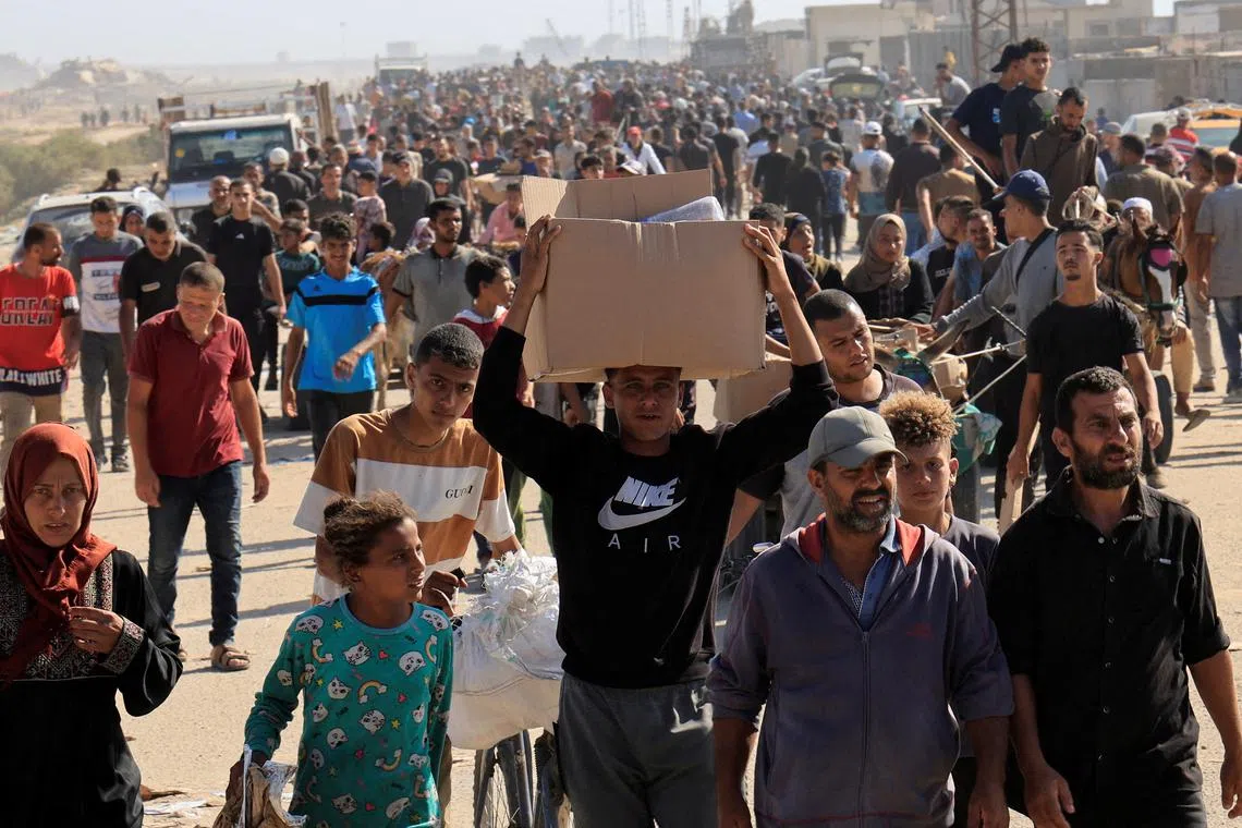 Palestinians seeking aid gather near an aid distribution site in Rafah on May 27.