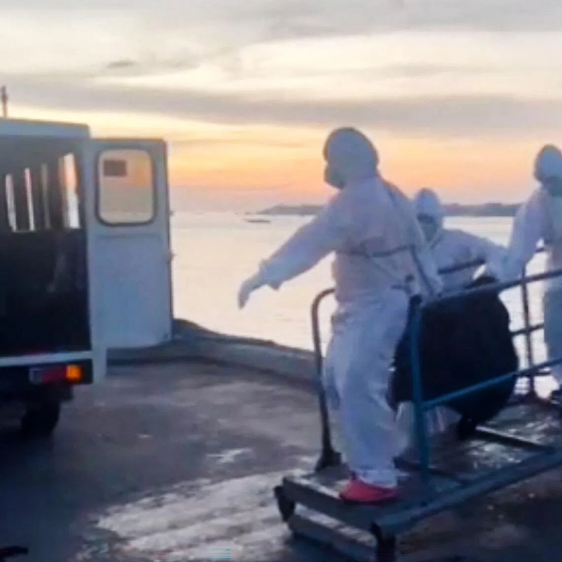 A handout video from the Philippine Coast Guard shows personnel carrying the body of a victim from the sunken MV Trisha Kerstin 3 on Jan 29.