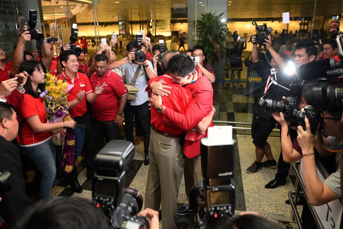 Joseph Schooling, Singapore's Olympic gold medallist and hero, hugging his father, Colin, after returning to Singapore on Aug 15, 2016. It was a heartwarming scene as father and son were reunited after months apart.