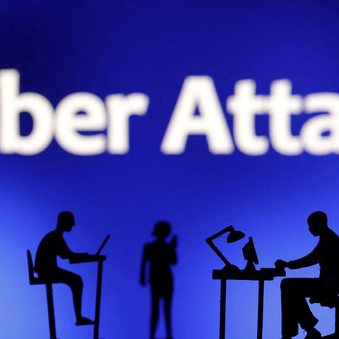 Figurines with computers and smartphones are seen in front of the words \"Cyber Attack\" in this illustration taken, February 19, 2024. REUTERS/Dado Ruvic/Illustration