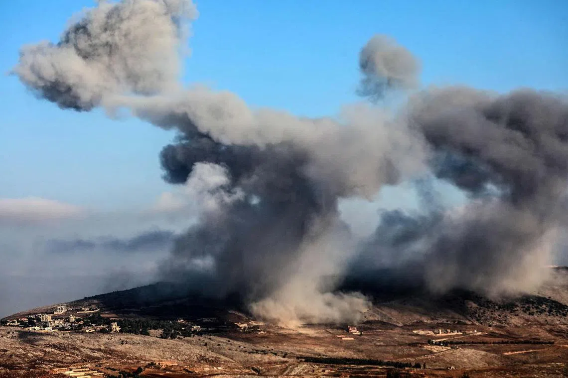 TOPSHOT - Plumes of smoke rise following an Israeli strike on the Ain el-Taher hill in the southern Lebanese village of Nabatiyeh al-Faouqa on August 31, 2025. (Photo by Rabih DAHER / AFP)
