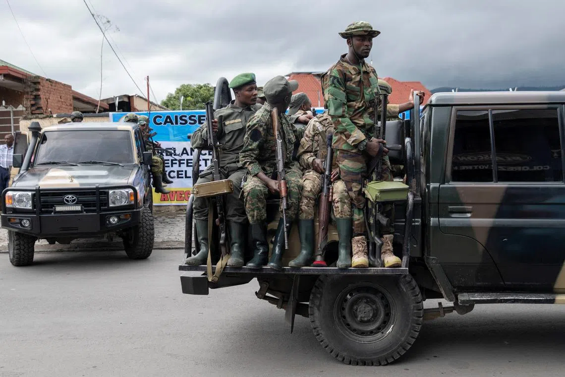 FILE PHOTO: Members of the M23 rebel group mount their vehicles after the opening ceremony of Caisse Generale d'epargne du Congo (CADECO) which will serve as the bank for the city of Goma where all banks have closed since the city was taken by the M23 rebels, in Goma, North Kivu province in the East of the Democratic Republic of Congo, April 7, 2025. REUTERS/Arlette Bashizi/File Photo