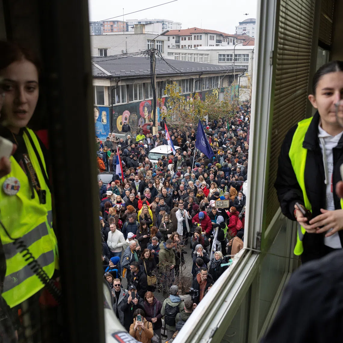 Students speak from their university's window during a protest over alleged government pressure on the State University of Novi Pazar, after many of its students lost their status and dozens of professors lost their jobs, in Novi Pazar, Serbia, December 21, 2025. REUTERS/Marko Djurica