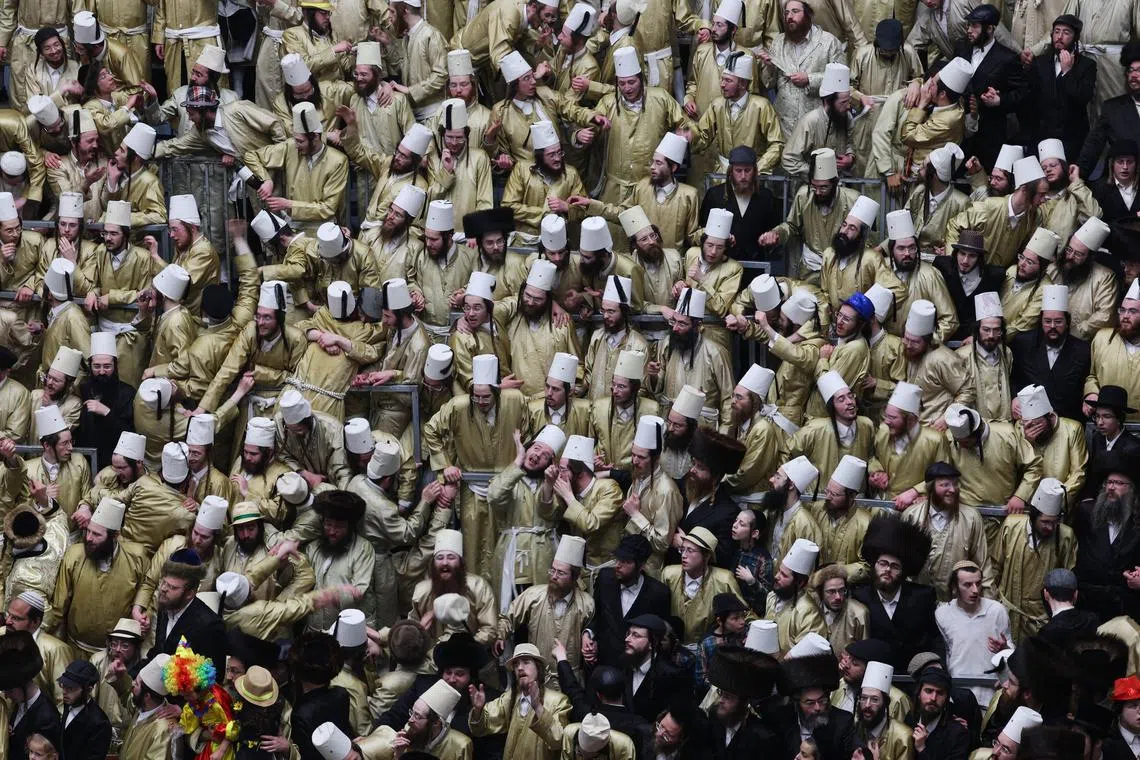epa11968644 Ultra-Orthodox Jews celebrate the Jewish holiday of Purim in the Mea Shearim neighborhood of Jerusalem, 16 March 2025. Purim celebrates the Jews' salvation from genocide in ancient Persia, as recounted in the Scroll of Esther, and it is a holiday of joyous celebrations, wearing costumes, and public drinking.  EPA-EFE/ABIR SULTAN