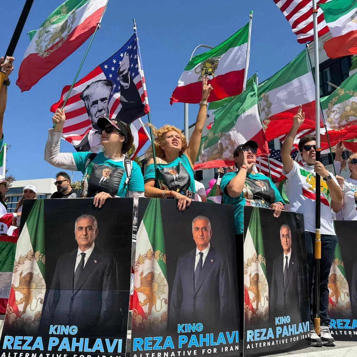 People wave US and pre-revolutionary Iranian flags as they protest the Iranian regime outside the SoFi Stadium in Inglewood, California, on June 7 ahead of the 2026 FIFA World Cup. 