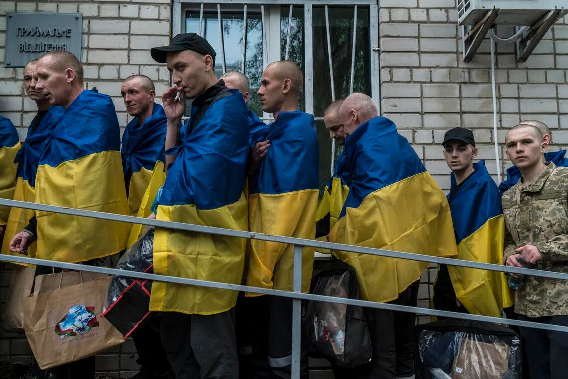 Ukrainian soldiers brought home by a prisoners of war exchange with Russia arrive in the Chernihiv region of Ukraine, May 6.