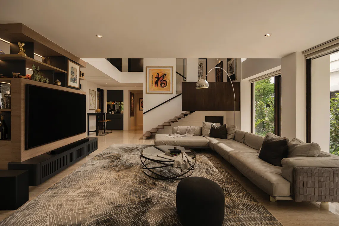 A display cabinet on the ground floor of this detached house acts as a divider between the living and dining areas.