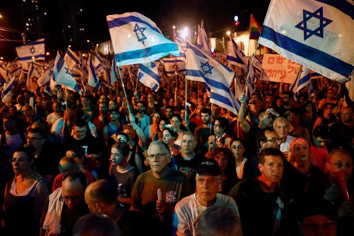 People take part in a demonstration against Israeli Prime Minister Benjamin Netanyahu and his nationalist coalition government's judicial overhaul, in Tel Aviv, Israel, July 22, 2023. REUTERS/Corinna Kern
