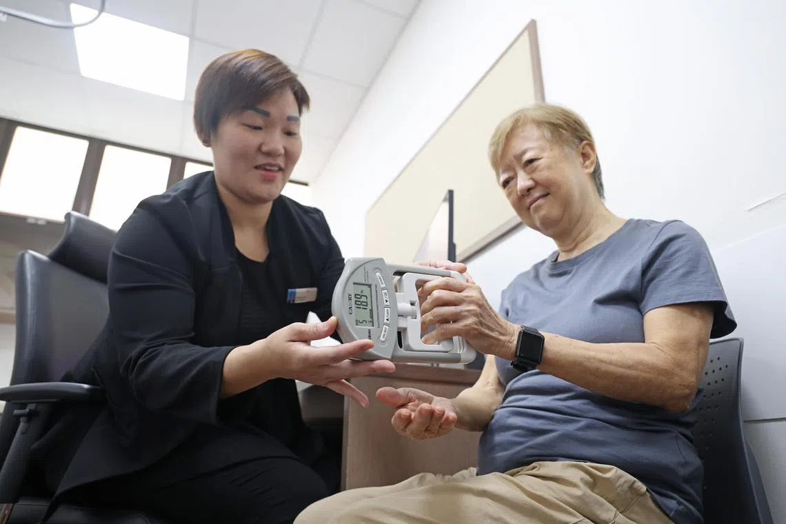 Under the supervision of Ms Doreen Chan, Senior Care Coordinator, Nursing Services, NHG Polyclinics, Ms Doris Yam, doing the hand grip test, one of the many test done under the frailty programme. A hand grip reading of 18 and above is considered to be ideal for women.

