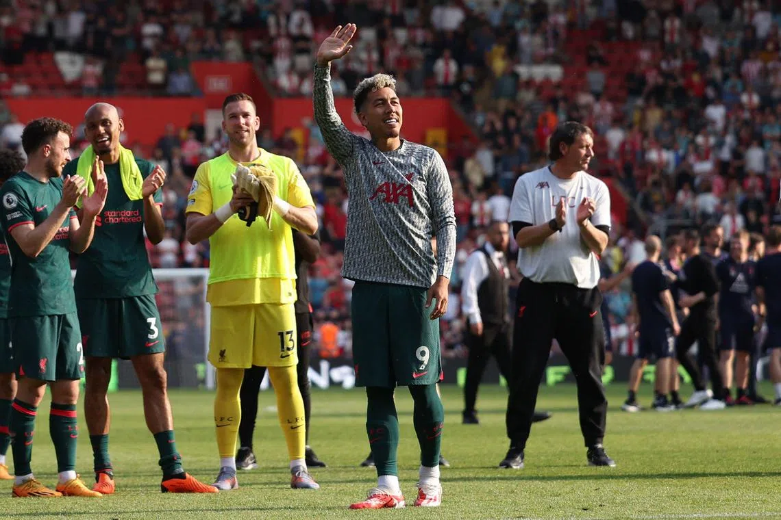 Liverpool striker Roberto Firmino is applauded by teammates on the pitch after the match against Southampton at St Mary's Stadium.