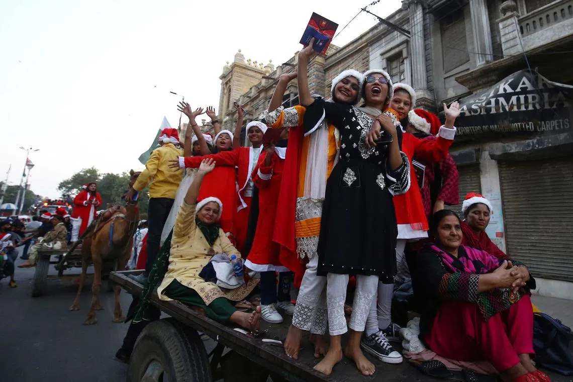 Members of the Pakistani Christian minority parade on a road ahead of Christmas, in Karachi, Pakistan, Dec 11, 2022.
