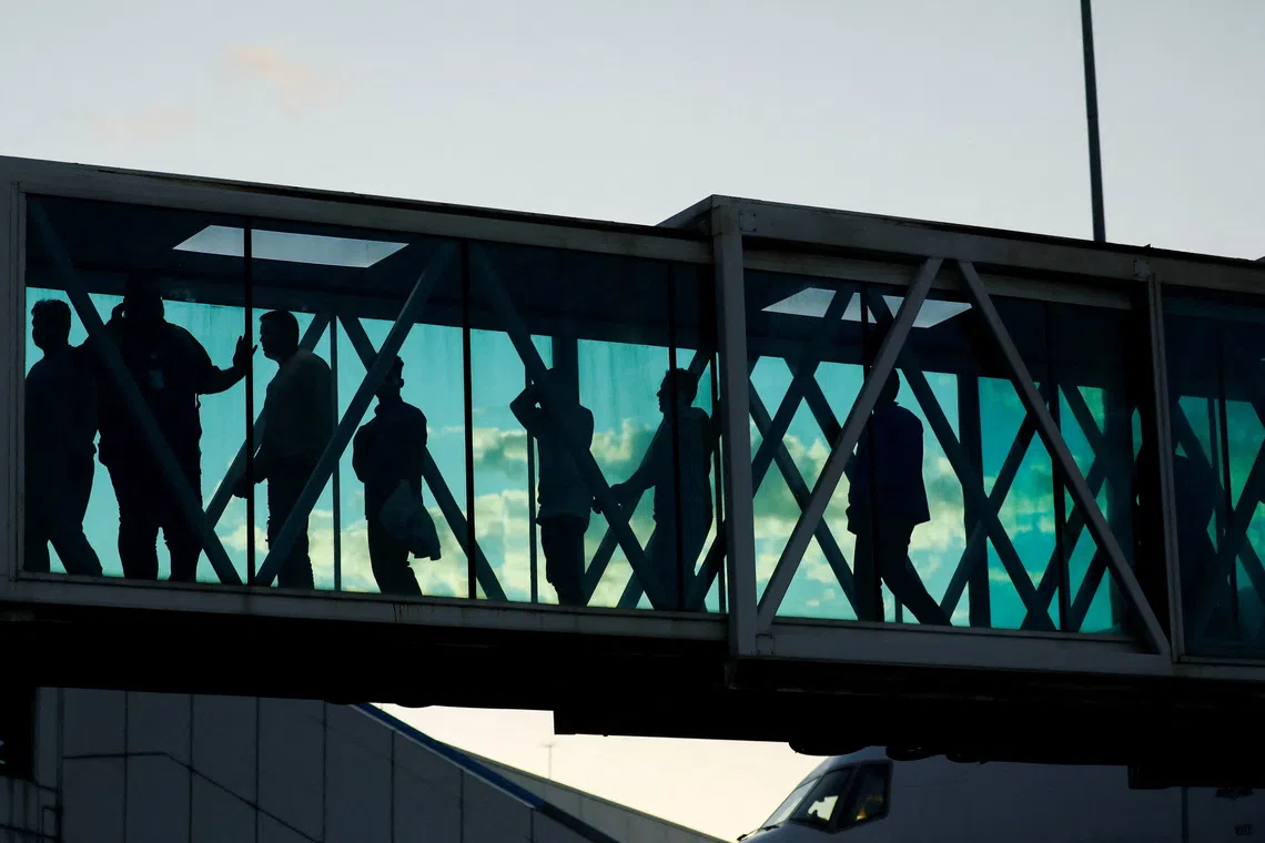 Venezuelan migrants in an aerobridge following their arrival on an Eastern Airlines plane from the United States, at the Simon Bolivar International Airport, in Maiquetia, Venezuela, on Dec 3, 2025. 