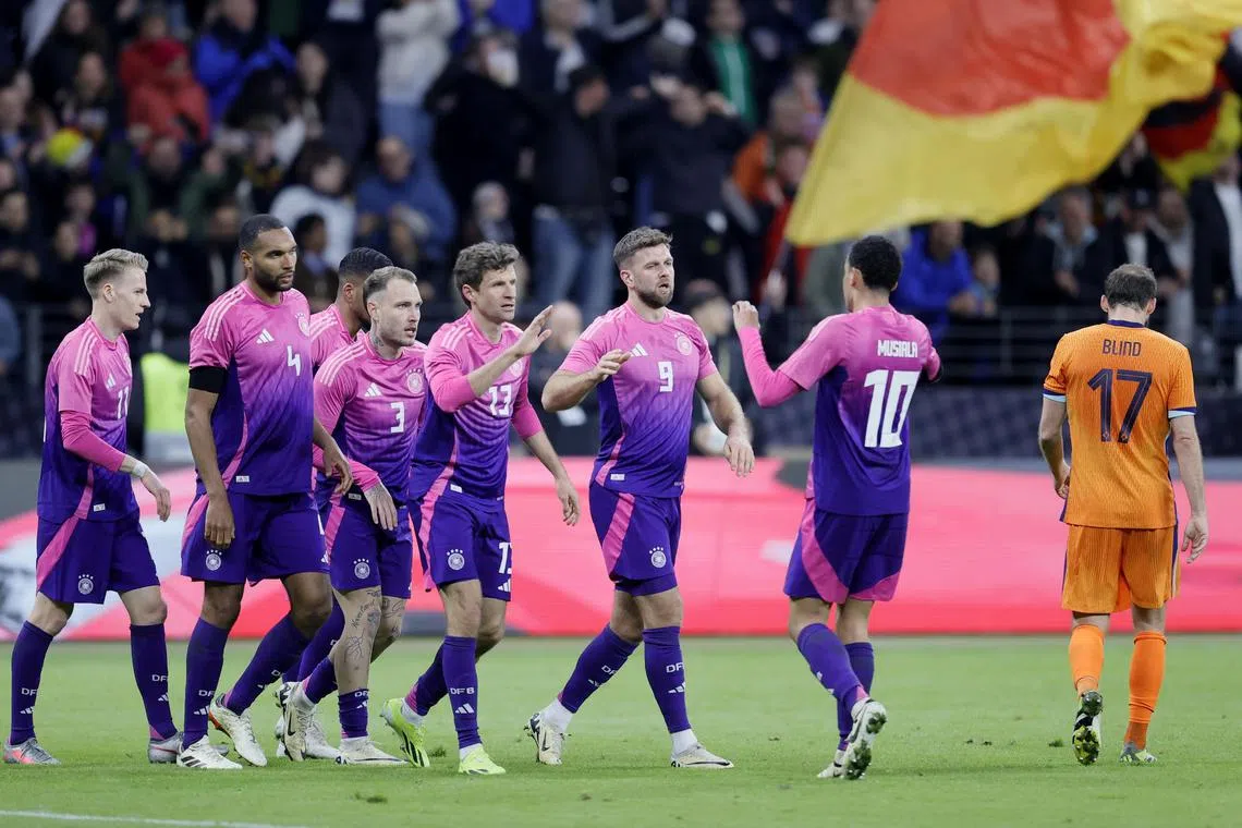 Germany's Niclas Fuellkrug celebrates with teammates after scoring against the Netherlands in the 2-1 friendly win.