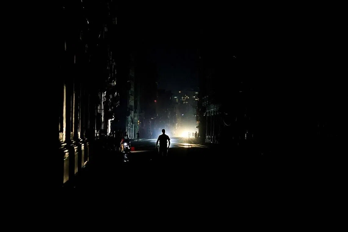A man walks on a street as Cuba's national electric grid collapsed at midday, leaving around 10 million people without power, in Havana, Cuba, July 6, 2026. REUTERS/Norlys Perez TPX IMAGES OF THE DAY