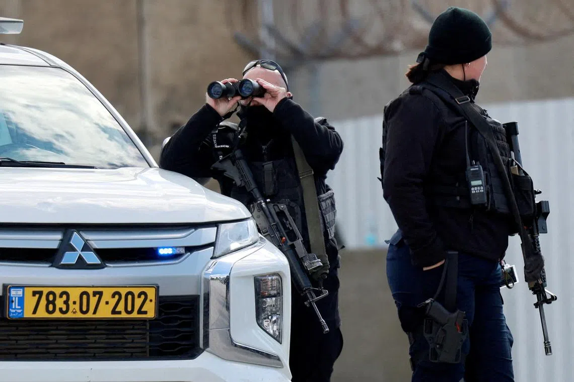 FILE PHOTO: Members of Israeli forces stand guard outside the Israeli military prison, Ofer, on the day Israel is expected to release Palestinian prisoners as part of a hostages-prisoners swap and a ceasefire deal in Gaza between Hamas and Israel, near Ramallah, in the Israeli-occupied West Bank, February 8, 2025. REUTERS/Ammar Awad/File Photo