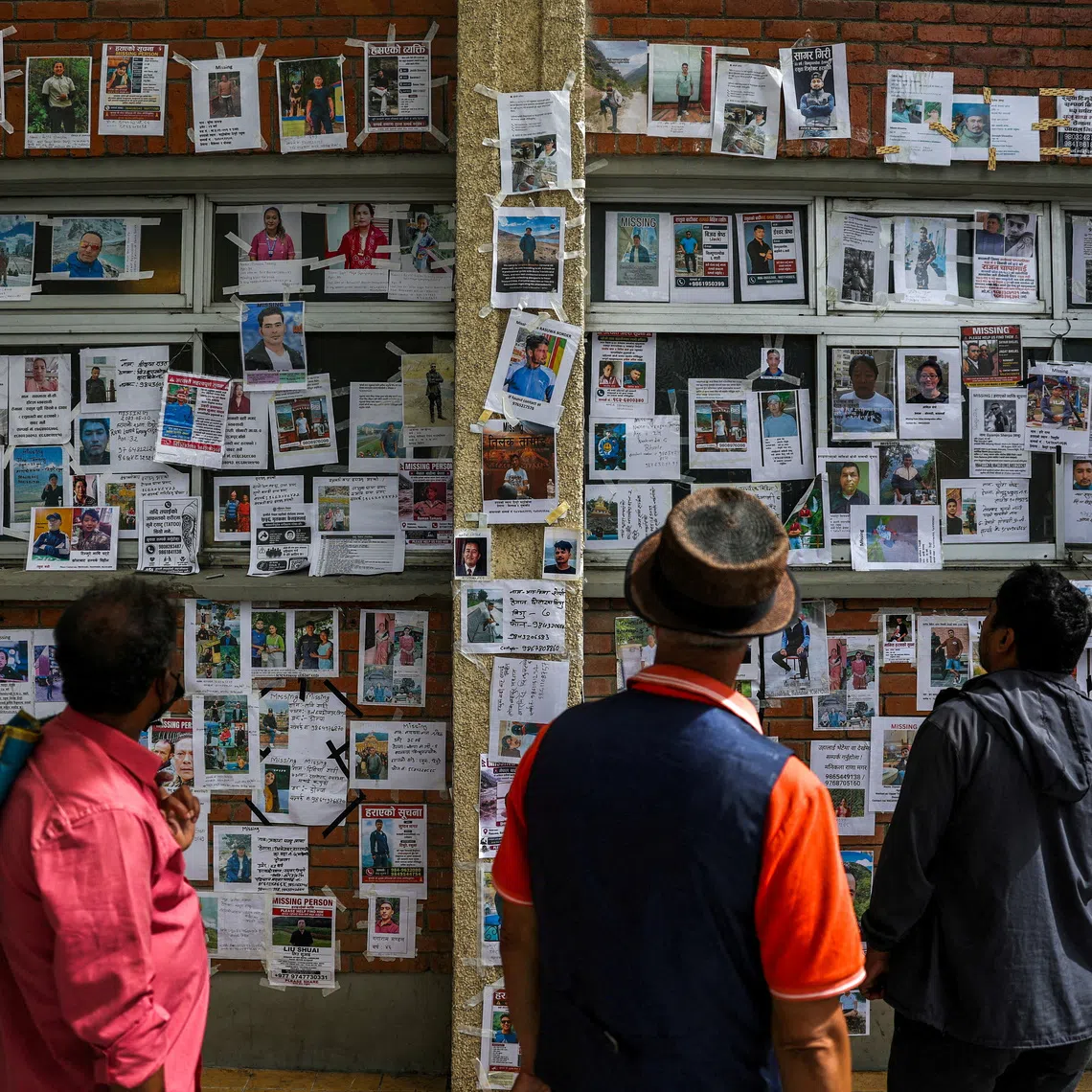 FILE PHOTO: People look at photographs of missing people on a wall outside Tribhuvan University Teaching Hospital following the deadly flash floods and mudslide, reacts outside Tribhuvan University Teaching Hospital, in Kathmandu, Nepal, September 2, 2026. REUTERS/Athit Perawongmetha /File Photo