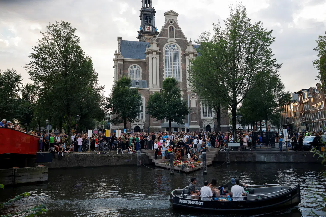 A memorial service for victims of the Berlin Pride attack takes place at the Homomonument in Amsterdam on July 28.