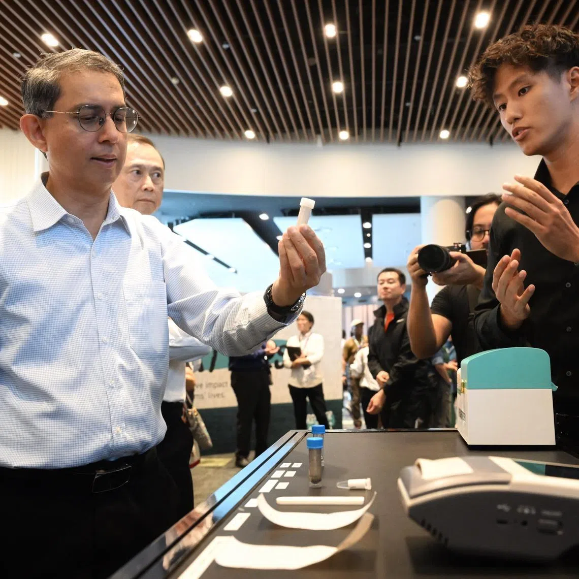 Slug: gwcnb10
ST PHOTO: Chong Jun Liang

Associate Professor Muhammad Faishal Ibrahim, Minister of State, Ministry of Home Affairs & Ministry of National Development taking a closer look at the Instant Hair Test Kit at the CNB Workplan Seminar on July 10, 2024.