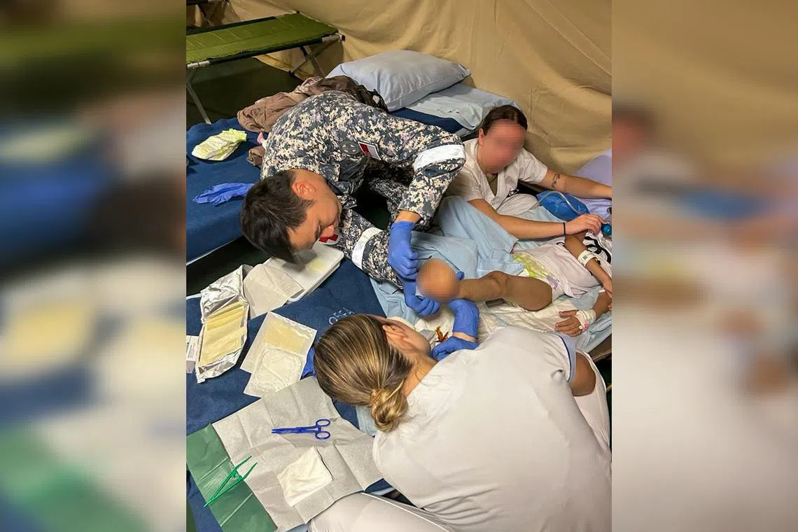 Military Expert 3 Jimmy Woo tends to the amputated left foot of a girl who had an infection.