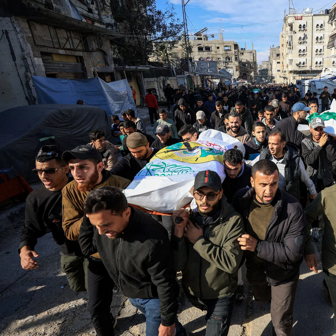 Mourners at the funeral of Hamas senior commander Raed Saed and his aides in Gaza City on Dec 14.