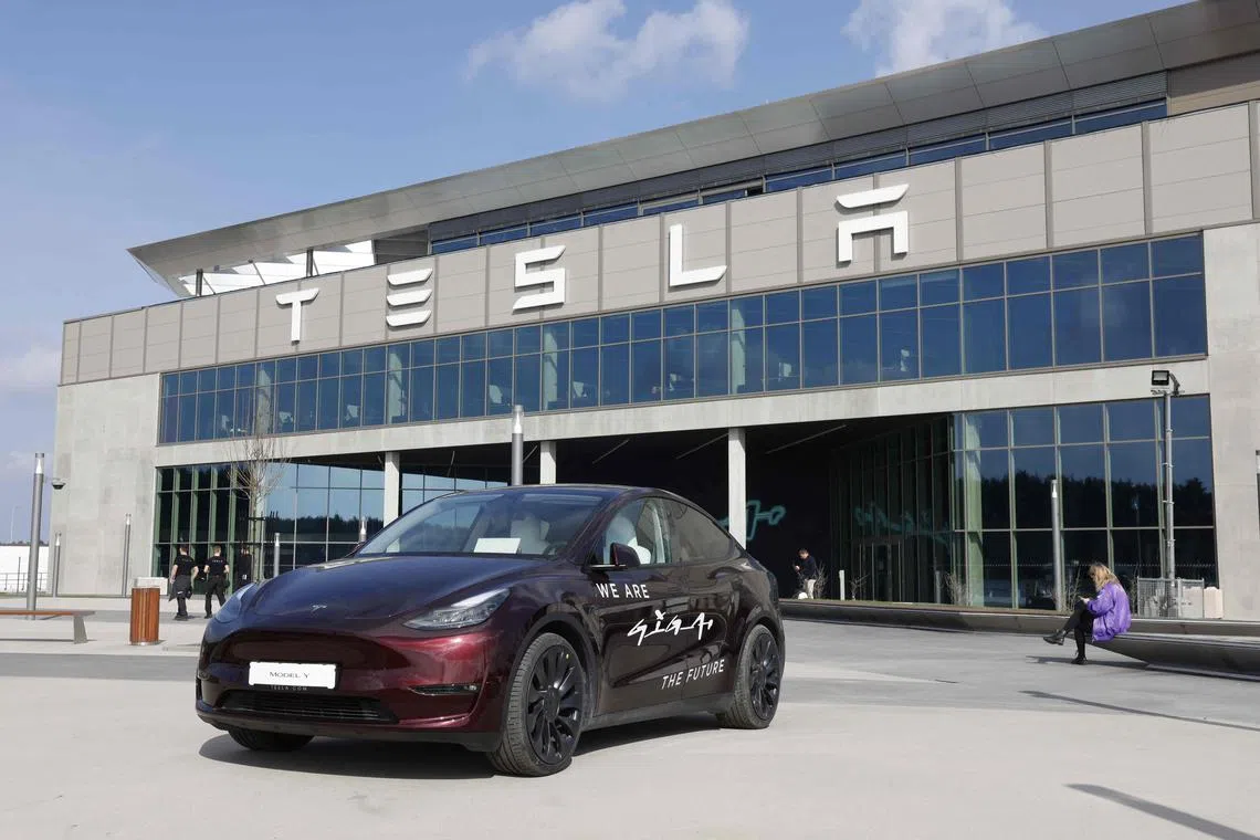 A Tesla Model y car stands in front of the company's plant as Tesla CEO Elon Musk visits the company's electric car plant in Gruenheide near Berlin, eastern Germany, on March 13, 2024, as employees resumed work after production had to be halted due to a suspected arson attack that caused a power outage. Damage to the lines knocked out power to the plant as well as cutting electricity to surrounding villages since power lines supplying the factory were set on fire in the early hours of March 5, 2024. Far-left activists from the "Vulkangruppe" (Volcano Group) have claimed responsibility for the sabotage, saying they aimed to achieve "the biggest possible blackout of the gigafactory", a reference to the Tesla plant. (Photo by Odd ANDERSEN / AFP)