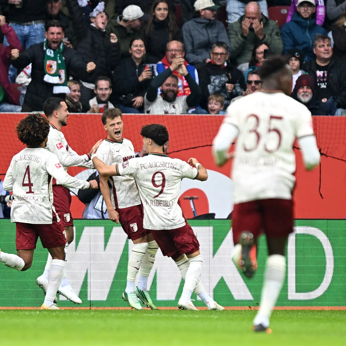 Soccer Football - Bundesliga - FC Augsburg v Bayern Munich - WWK Arena, Augsburg, Germany - October 10, 2026 FC Augsburg's Robin Fellhauer celebrates scoring their first goal with teammates REUTERS/Angelika Warmuth