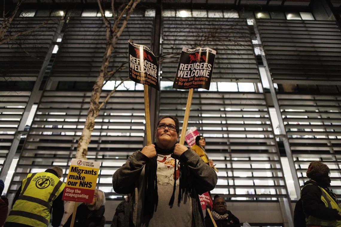 Pro-immigration campaigners protest against the UK government's immigration policies on International Migrants Day outside the UK Home Office in London on Dec 18, 2023.