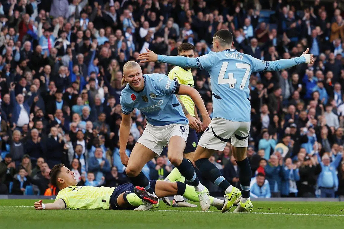 Manchester City's Erling Haaland celebrates scoring their first goal with Phil Foden in the Premier League clash with Southampton.