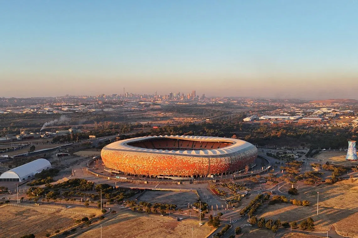 FILE PHOTO: A drone view of the FNB Stadium, one of South Africa's landmarks, which hosted both the opening match and the final of the 2010 FIFA World Cup, with the cityscape of Johannesburg seen in the background, South Africa July 11, 2025. REUTERS/Siphiwe Sibeko/File Photo