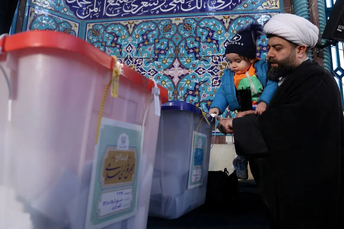 FILE PHOTO: An Iranian cleric casts his vote during parliamentary elections at a polling station in Tehran, Iran, March 1, 2024. Majid Asgaripour/WANA (West Asia News Agency) via REUTERS/ File Photo