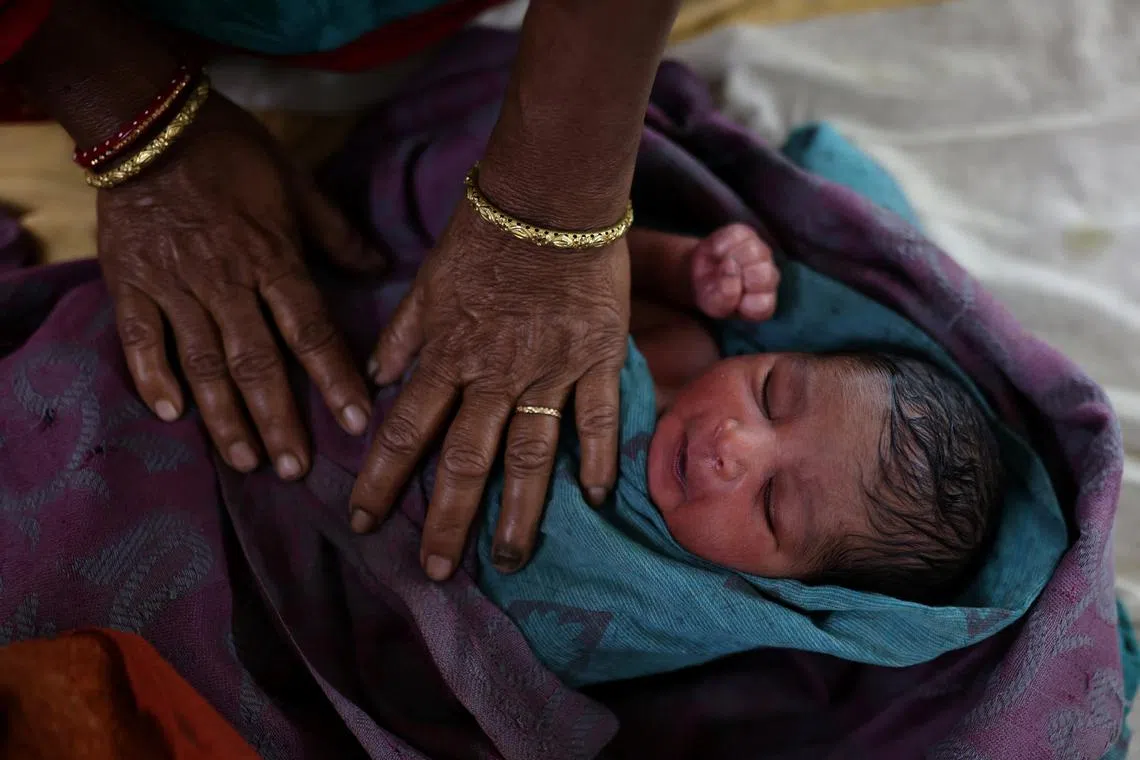 A nurse taking care of a newborn baby after the birth at a hospital in Kishanganj district March 20.