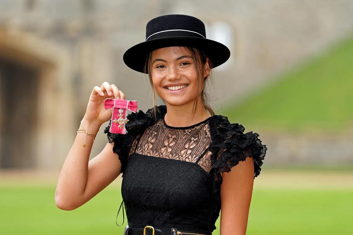 British tennis player Emma Raducanu poses after receiving her MBE from King Charles III.