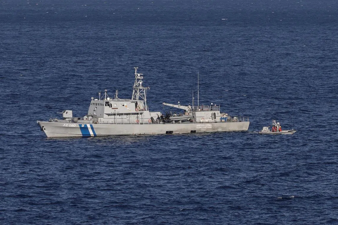 A Greek coast guard ship searches for survivors following a shipwreck off the island of Samos.