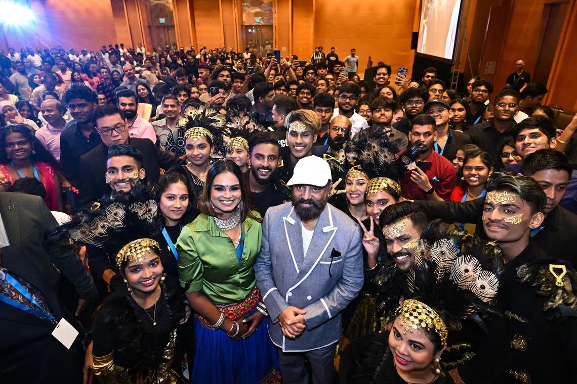 Star Kamal Hassan (in white cap) taking a group photograph with performers and fans during a fans meet event for upcoming movie Indian 2. 