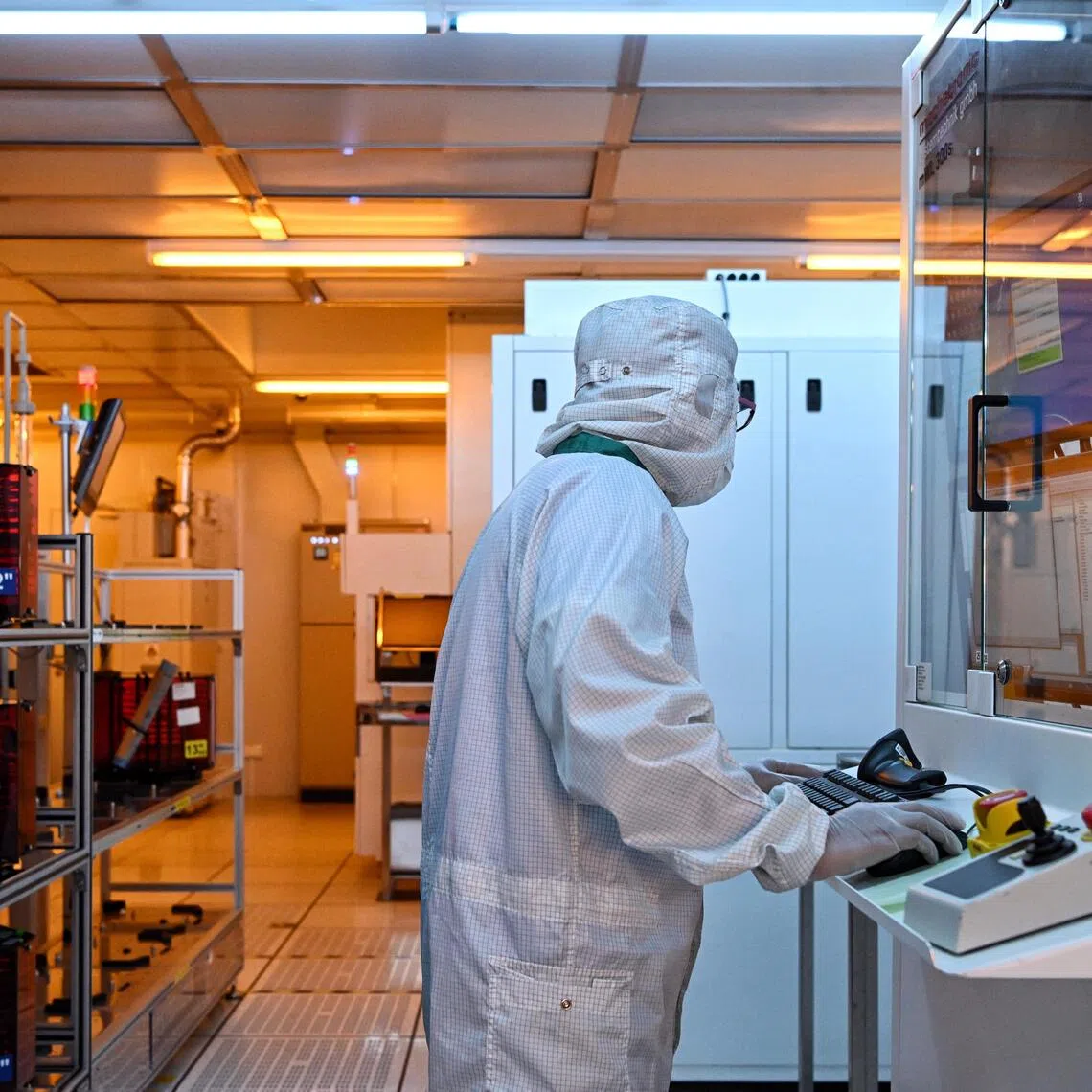 Generic pix of a worker in the clean room processing Wafer-level packaging (WLP) at the Singapore semiconductor firm, STATS ChipPAC office in Yishun on April 12, 2023. Can be used for stories about manufacturing, semiconductors, electronic industry, clean room, wafer fabrication.