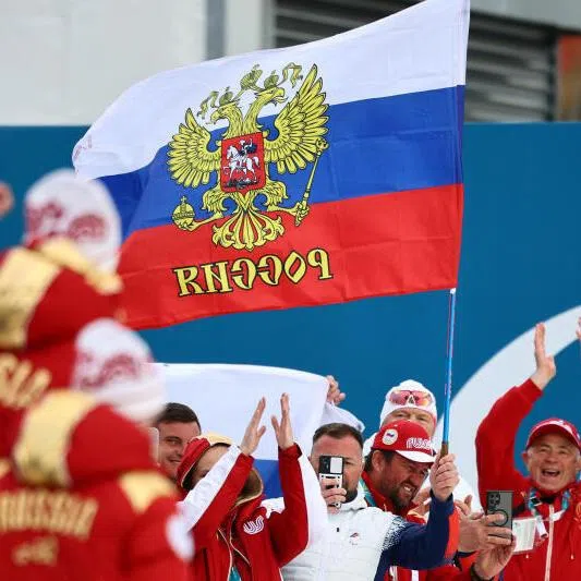 Fans with the flag of Russia are pictured ahead of the victory ceremony at the Milano Cortina 2026 Paralympics event.