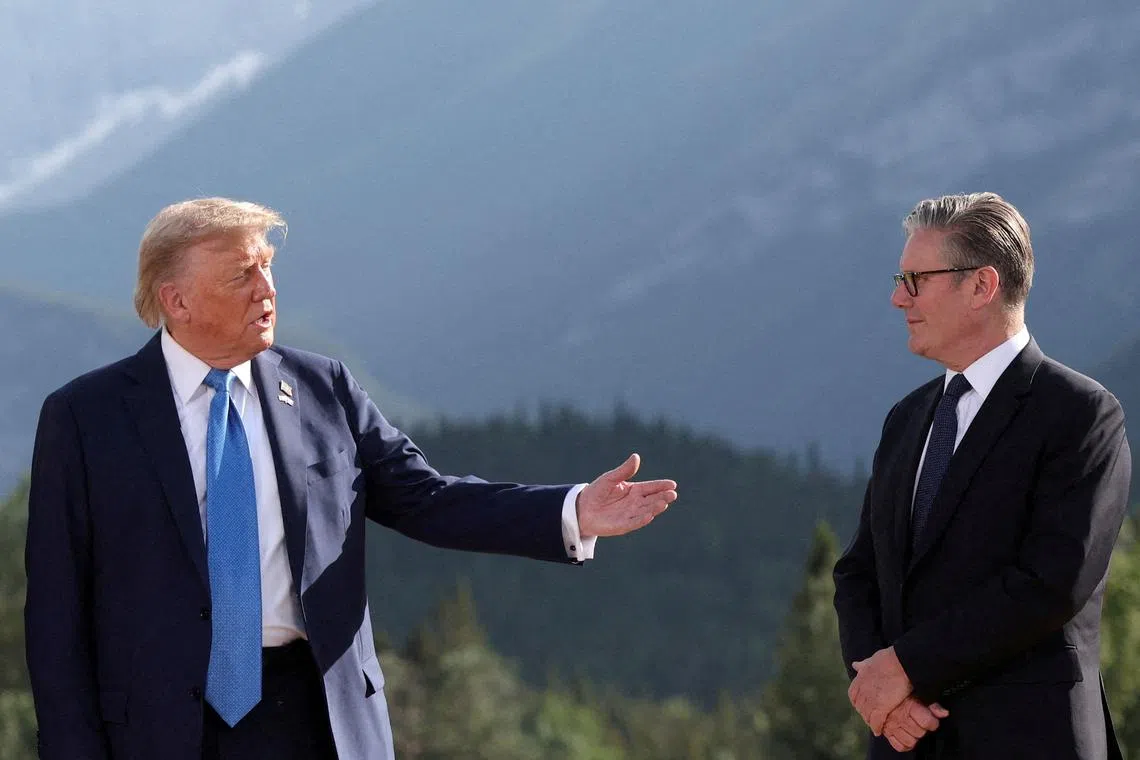 FILE PHOTO: U.S. President Donald Trump and British Prime Minister Keir Starmer attend a photo session during the G7 Summit, in Kananaskis, Alberta, Canada, June 16, 2025. REUTERS/Suzanne Plunkett/Pool/File Photo