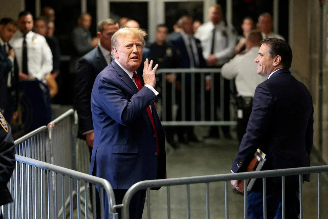 FILE PHOTO: Former U.S. President Donald Trump gestures outside the courtroom on the day of a court hearing on charges of falsifying business records to cover up a hush money payment to a porn star before the 2016 election, in New York State Supreme Court in the Manhattan borough of New York City, U.S., February 15, 2024. REUTERS/Andrew Kelly/File Photo