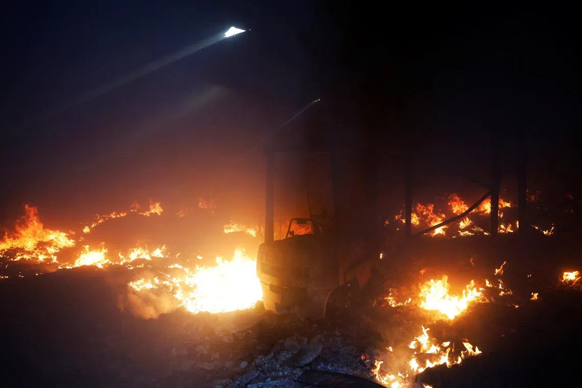 A warehouse burns in a wildfire in Cubo de Benavente, Spain, August 11, 2025. REUTERS/Susana Vera