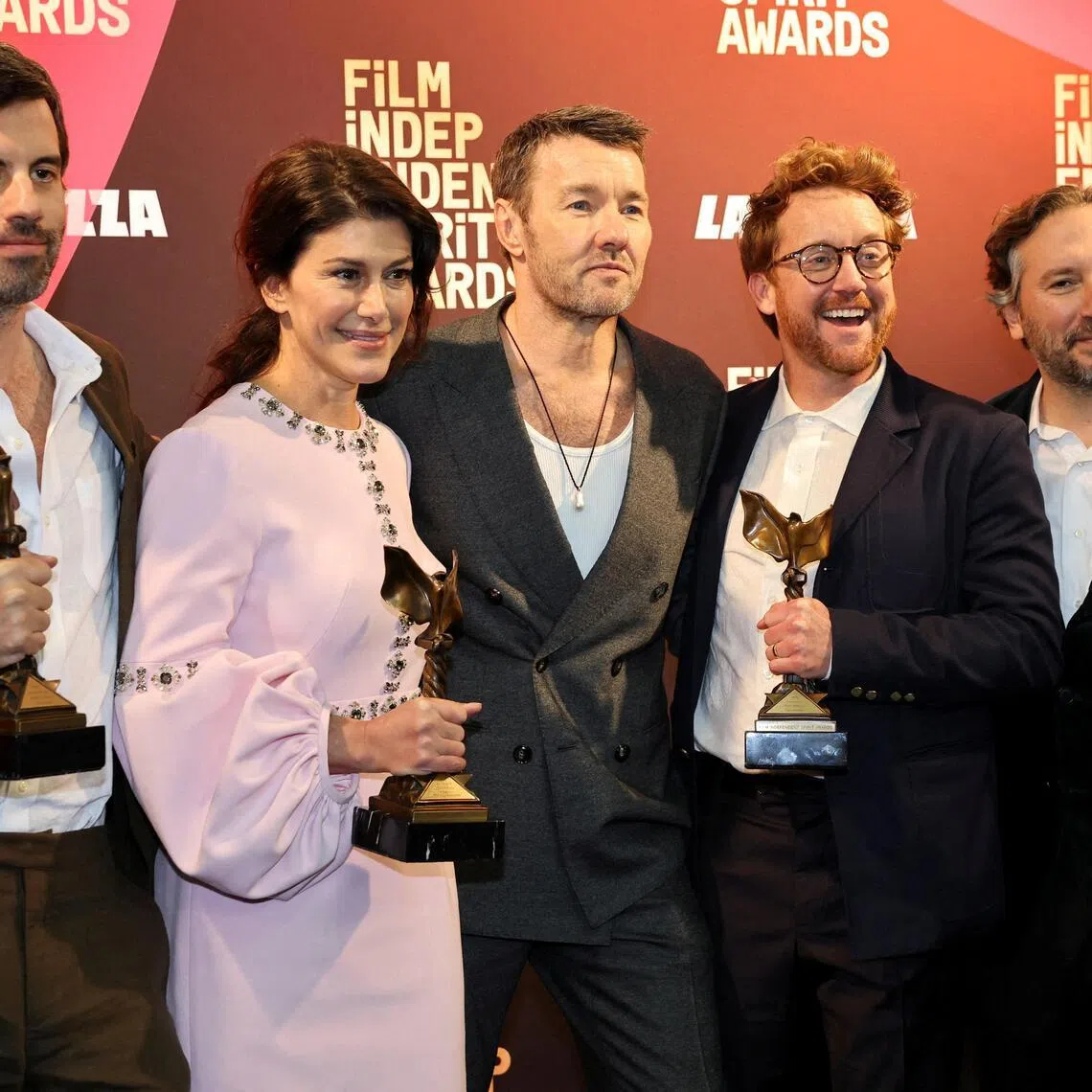 (From left) Brazilian cinematographer Adolpho Veloso, producer Marissa McMahon, Australian actor Joel Edgerton, director Clint Bentley and producer Teddy Schwarzman pose with the awards for Train Dreams during the Film Independent Spirit Awards on Feb 15.