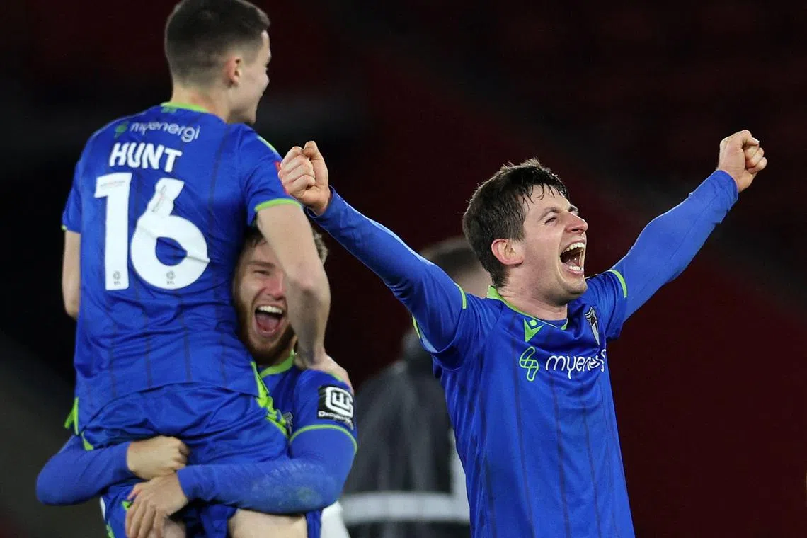 Grimsby players celebrate after winning the the English FA Cup fifth round football match against Southampton on March 1, 2023.