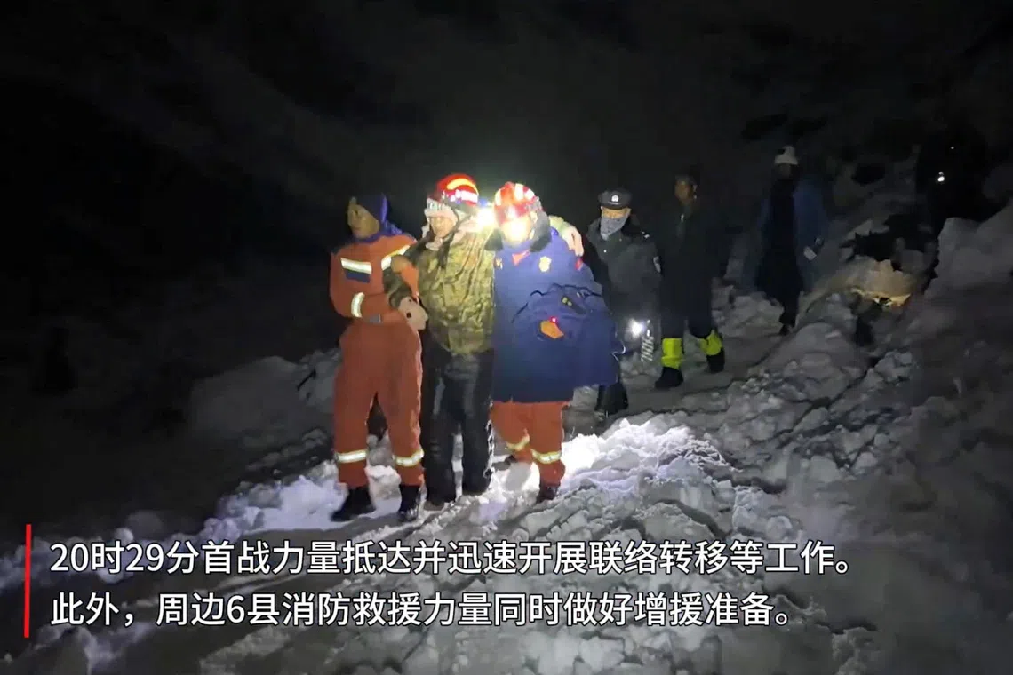 Tibetan firefighters rescue trekkers from Everest after they were stranded by a blizzard, in Tingri, Tibet Autonomous Region, China, in this screen grab taken from a video released on October 6, 2025.  Tibet Firefighting Department/Handout via REUTERS