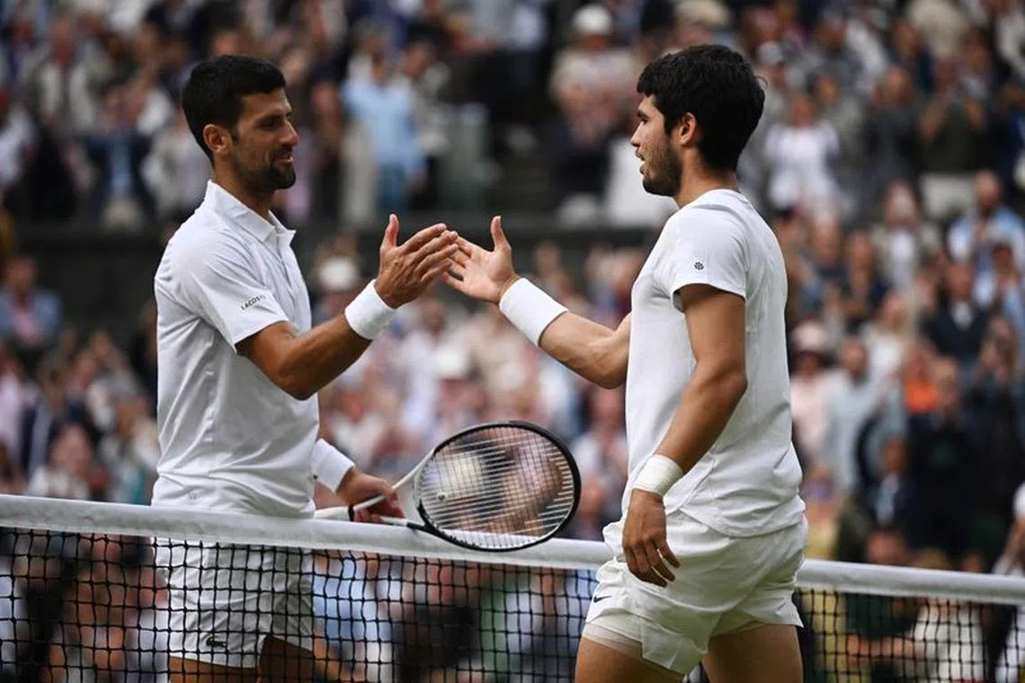 FILE PHOTO: Tennis - Wimbledon - All England Lawn Tennis and Croquet Club, London, Britain - July 16, 2023 Spain's Carlos Alcaraz shakes hands with Serbia's Novak Djokovic after winning the final REUTERS/Dylan Martinez/File photo