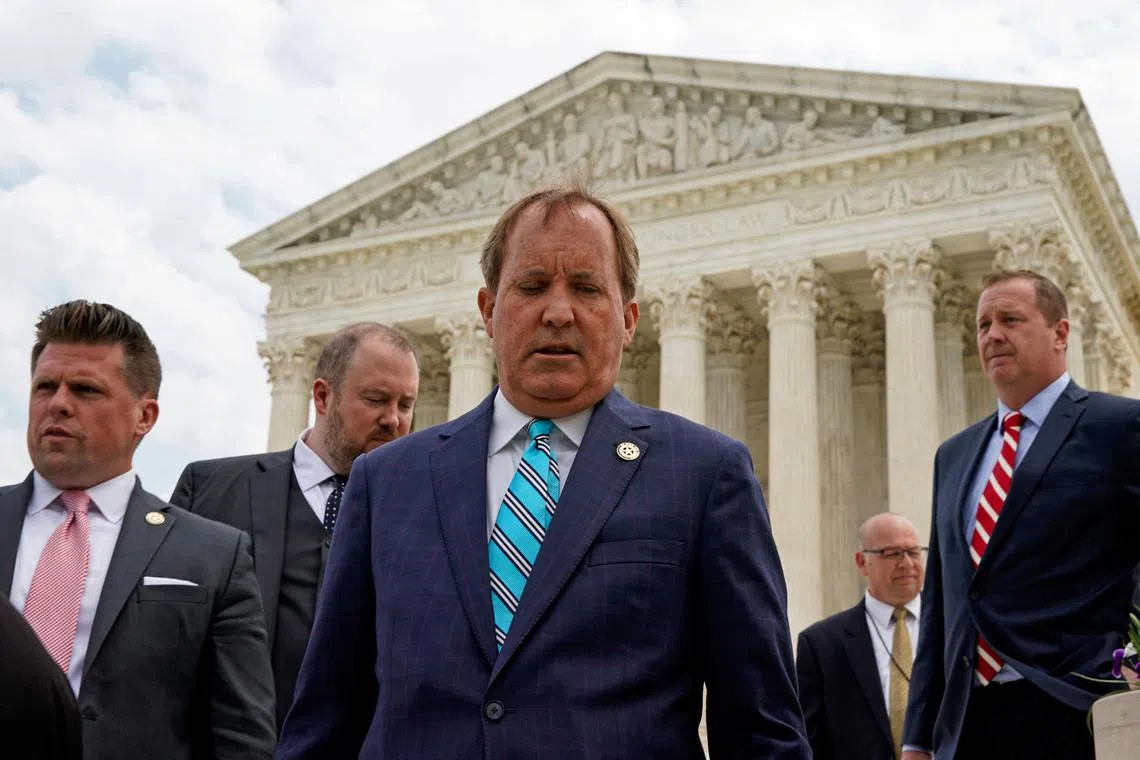 Texas Attorney General Ken Paxton leaves a news conference in Washington in this file photo from 26 April 2022.