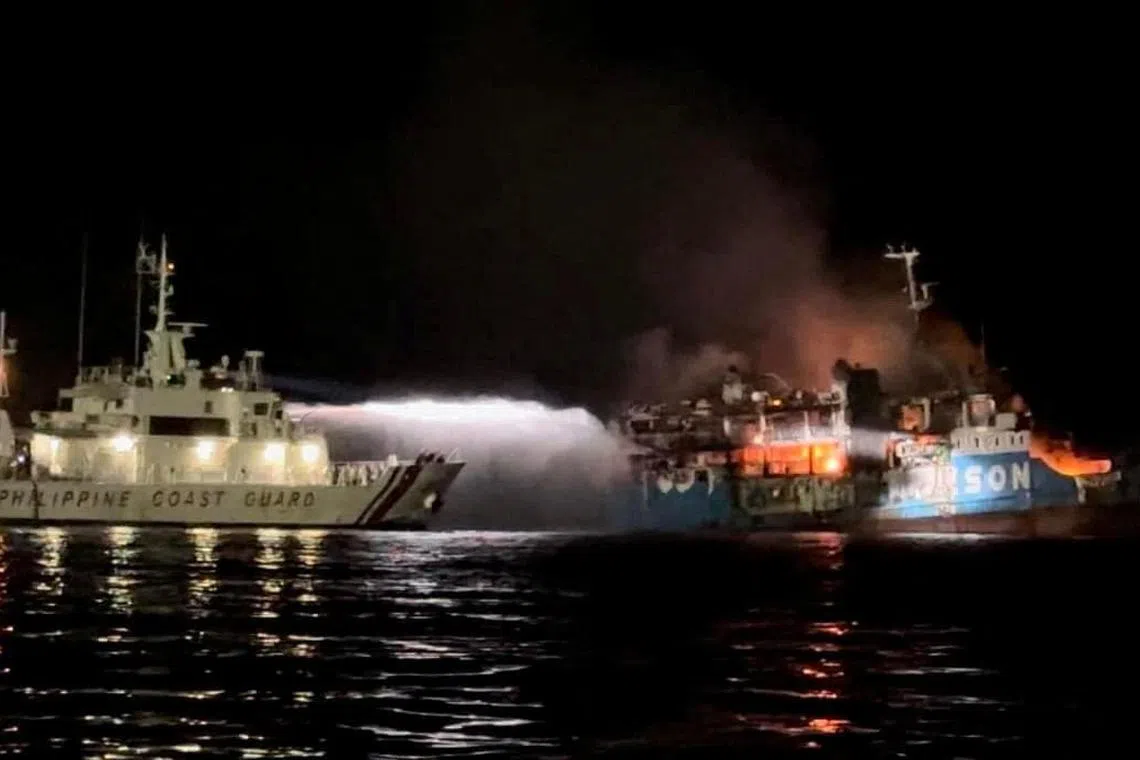 Philippine Coast Guard respond to the fire onboard MV Lady Mary Joy 3 in the seas off the southern Philippine province of Basilan. 